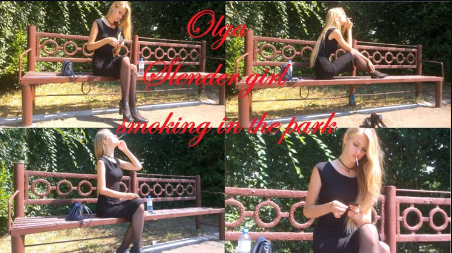 Slender girl Olga smoking in the park